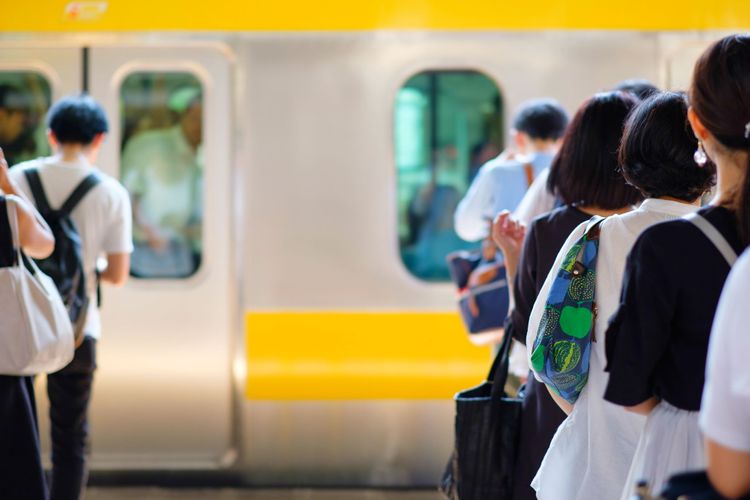 passengers lining up for a train