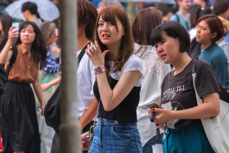 Two Japanese women in a crowded outdoor space