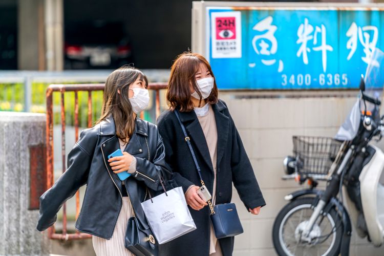 two Japanese women wearing masks