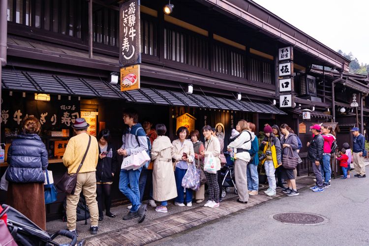 long queue outside of Sushi restaurant Japan